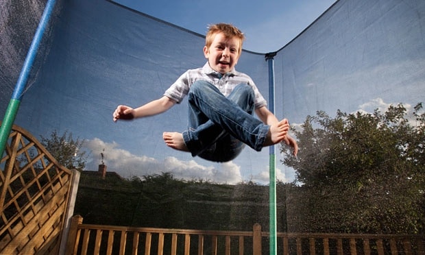 kid jumping on a trampoline