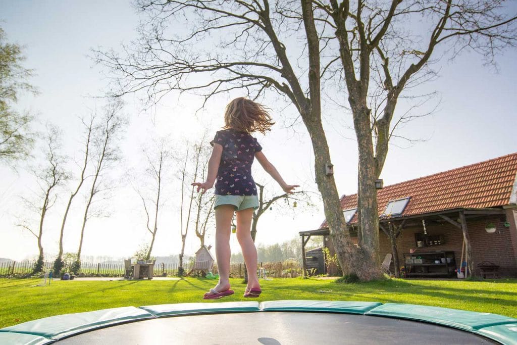 girl playing at a trampoline
